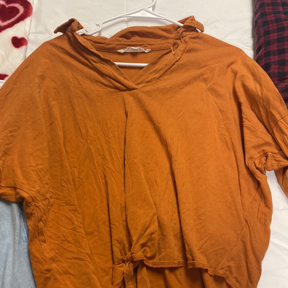 Orange long sleeve with collar and tie at the front